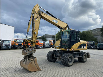Grävmaskin på däck CAT M313D Mobilbagger *11.400 h *Hammerleitung