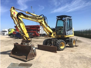 Grävmaskin på däck NEW HOLLAND
