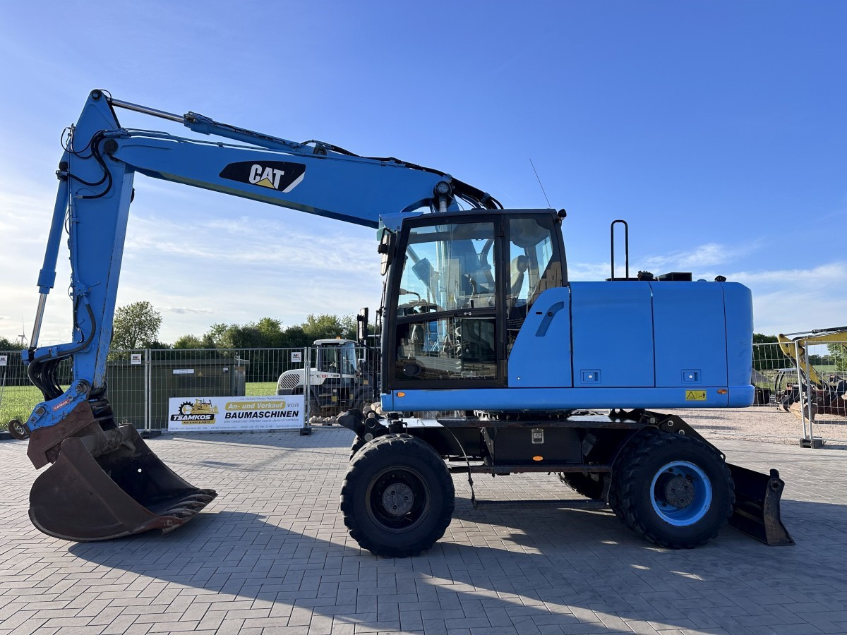 CATERPILLAR M 318 F Oil Quick OQ 65 Deutsche Maschine Top ! - Grävmaskin på däck: bild 1 CATERPILLAR M 318 F Oil Quick OQ 65 Deutsche Maschine Top ! - Grävmaskin på däck: bild 1