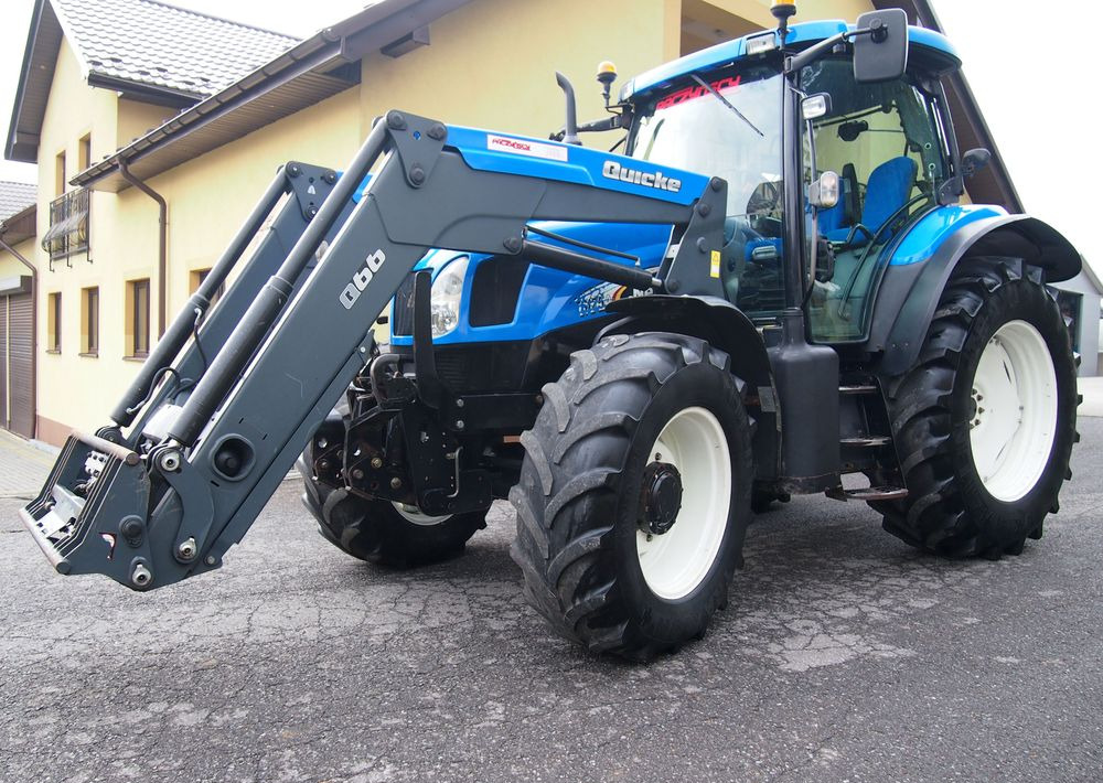 Ciągnik New Holland NH TS125A 6 cylindrów 2004 Ciągnik rolniczy New Holland TS125A - Traktor: bild 1 Ciągnik New Holland NH TS125A 6 cylindrów 2004 Ciągnik rolniczy New Holland TS125A - Traktor: bild 1