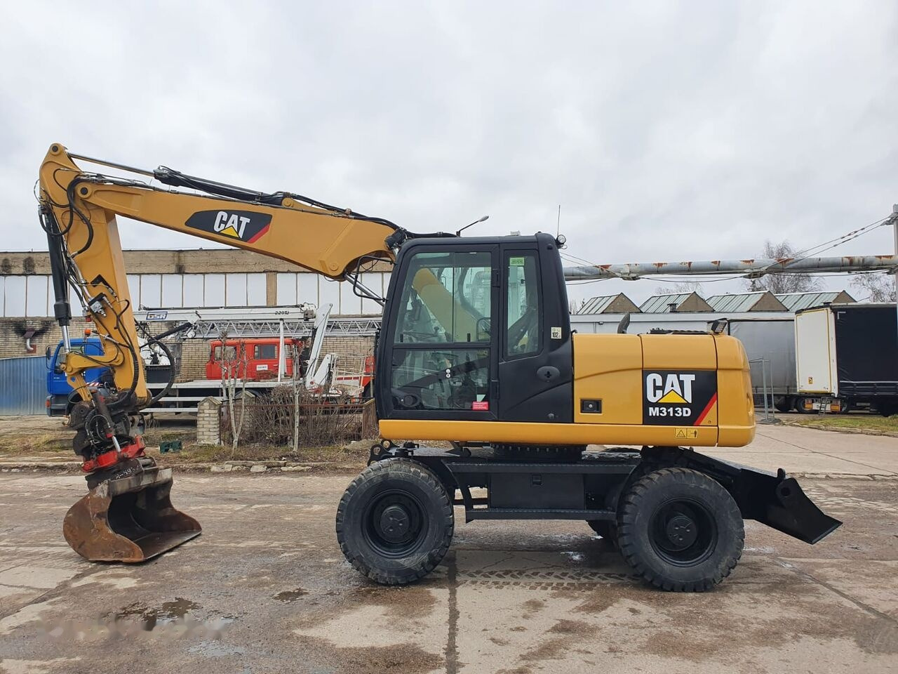 Caterpillar M 313 D Tiltrotator - Grävmaskin på däck: bild 1 Caterpillar M 313 D Tiltrotator - Grävmaskin på däck: bild 1