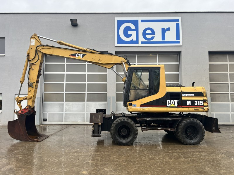 Caterpillar M 315 (111063) - Grävmaskin på däck: bild 1 Caterpillar M 315 (111063) - Grävmaskin på däck: bild 1
